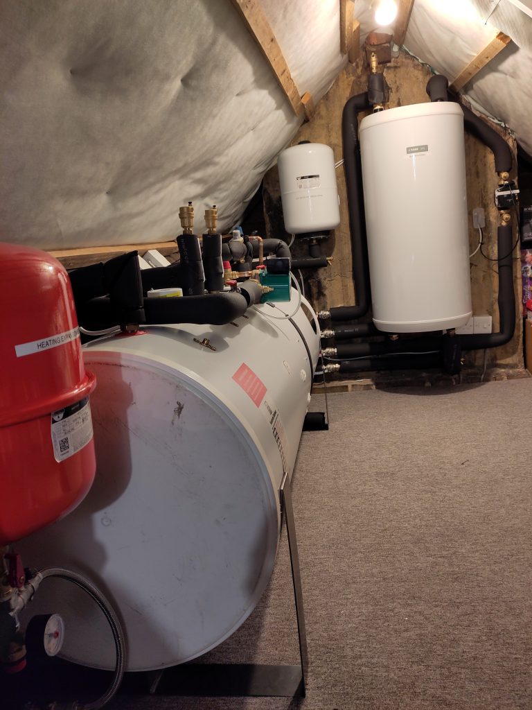 This image shows the tank and workings for a ground source heat pump installed in a loft space.